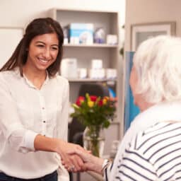 Audiologist and patient shaking hands