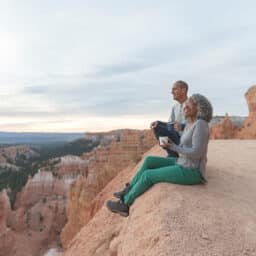 Older couple from Utah on a hike, taking a break to have a drink and enjoy the scenery.
